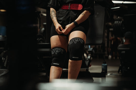 woman wearing uppper knee sleeves