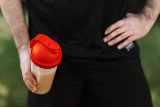 man holding shaker bottle