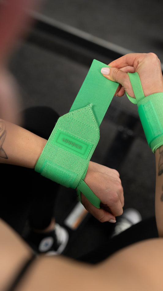 woman putting on uppper wrist wraps